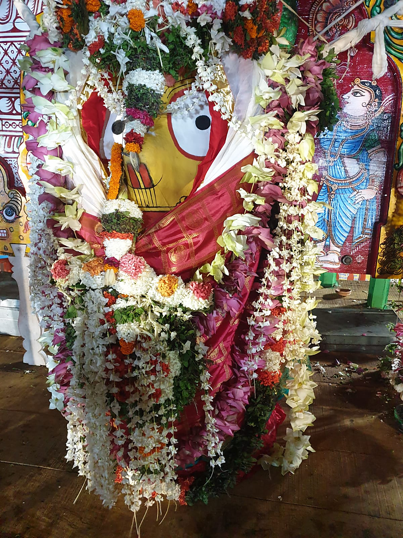 Lord Balabhadra adorned with cascading garlands of jasmine, lotus and tulsi upon the Taladhwaja chariot