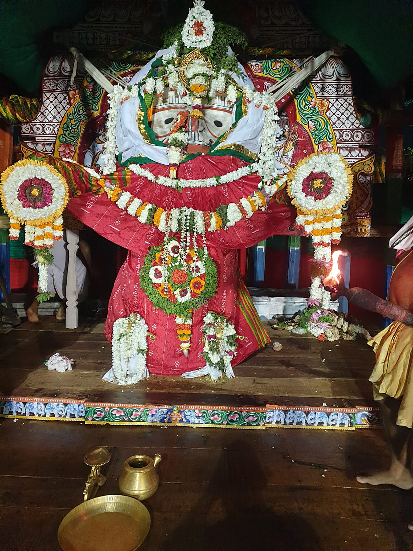Arati offered to the Lord in the evening, the chariot glowing with lamps and floral ornaments
